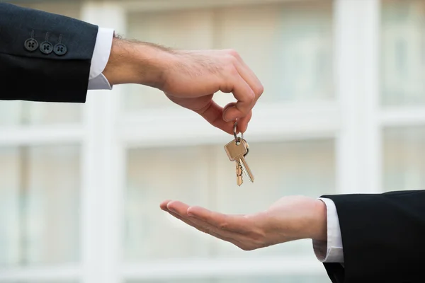 Real Estate Agent Giving House Keys