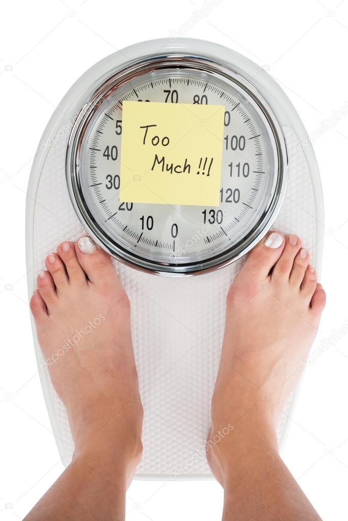 Woman Standing On Weight Scale
