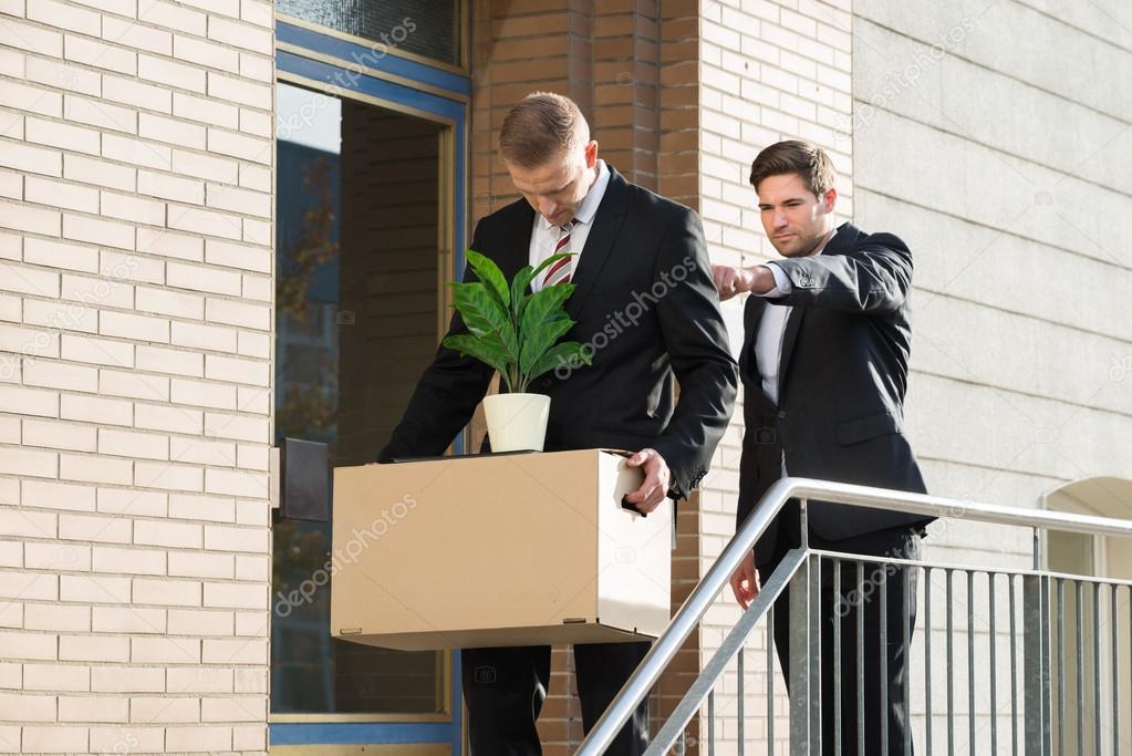 Businessman Firing Employee Outside Office