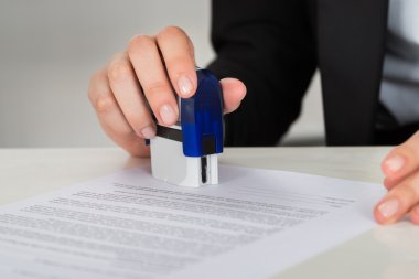 Businesswoman Stamping Contract Document