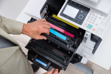 Businessman Fixing Cartridge In Photocopy Machine clipart