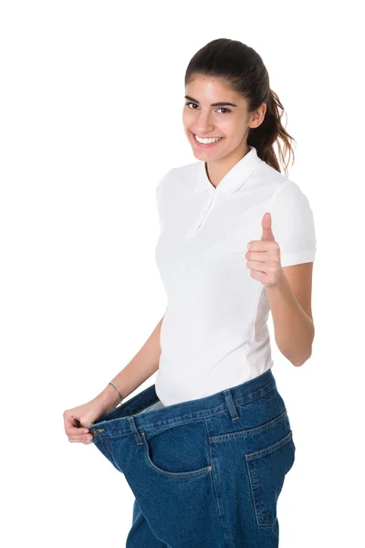 Smiling Woman Showing Her Old Jeans — Stok Foto