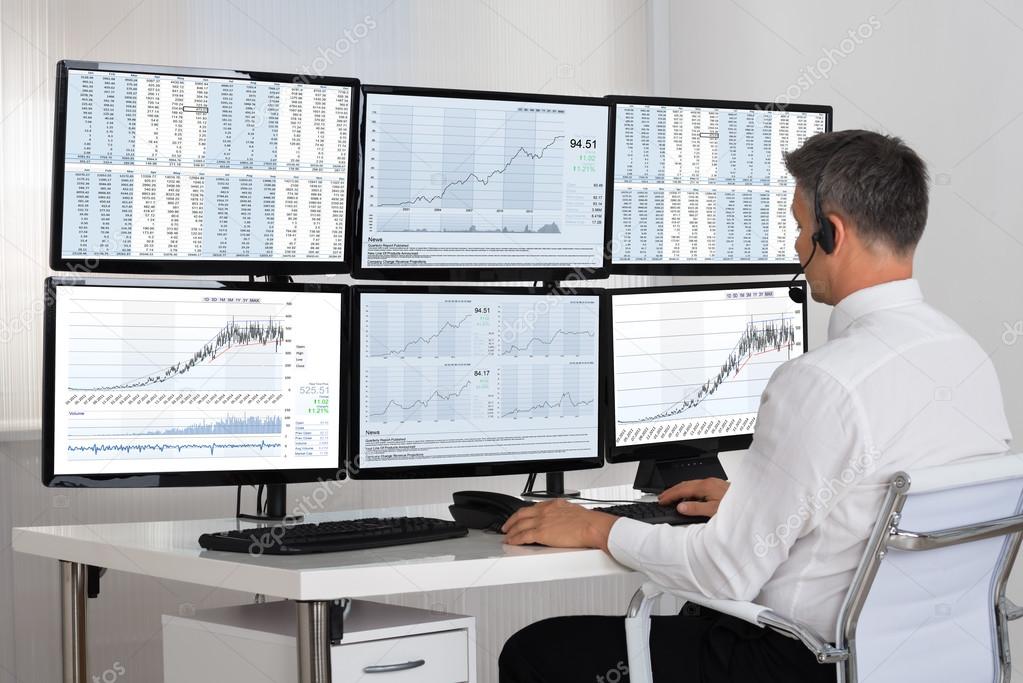 Stock Market Broker Looking At Graphs