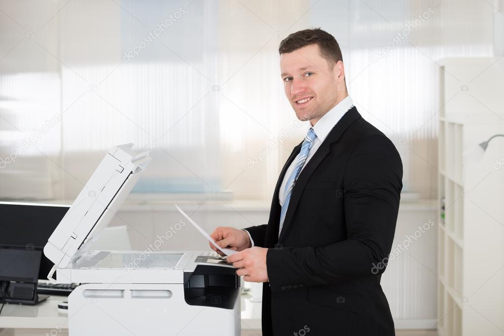 Businessman Using Photocopy Machine