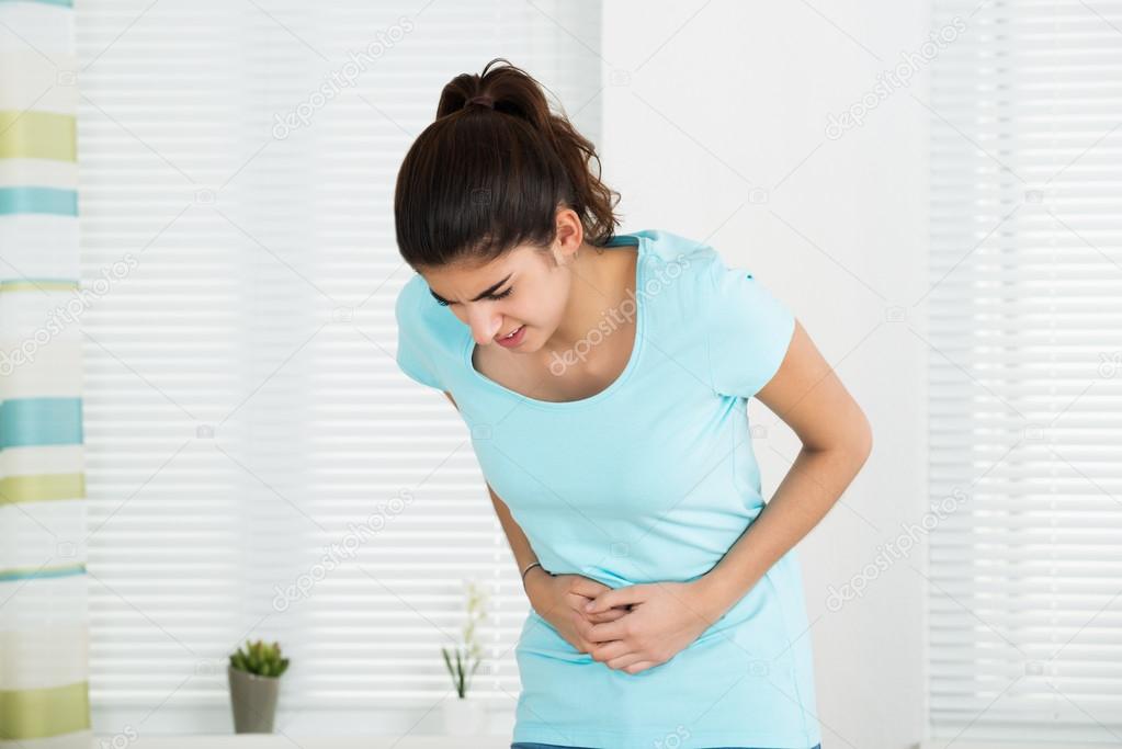 Woman Suffering From Stomach Ache — Stock Photo © AndreyPopov 97934454