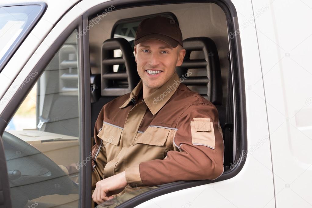 Confident Delivery Man Smiling In Truck