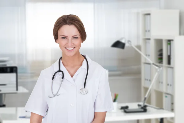 Zelfverzekerde vrouwelijke arts glimlachend — Stockfoto