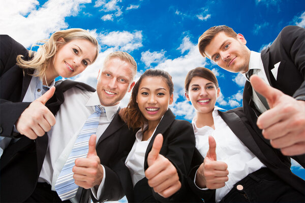 Confident BusinessTeam Showing Thumbs Up