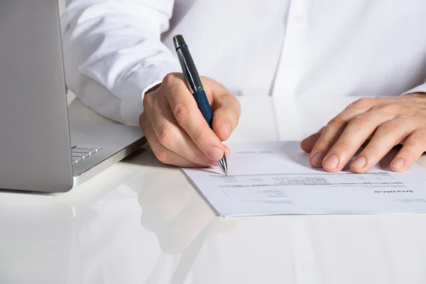 Businessman Analyzing Invoice By Laptop — Stock Photo, Image