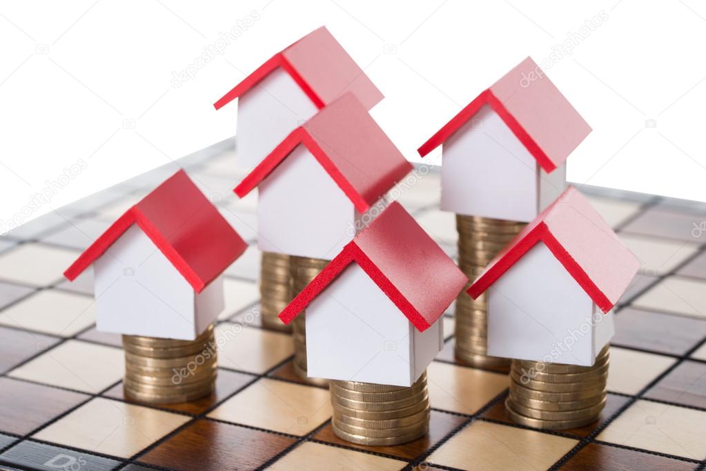 House Models And Stacked Coins