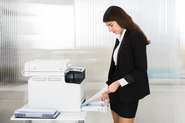 Businesswoman Inserting Papers In Photocopy Machine — Stok Foto