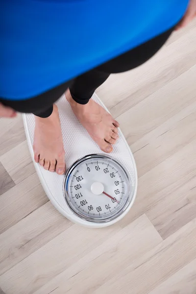 Жінка вимірює вагу на шкалі зважування — стокове фото