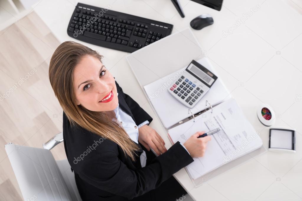 Happy Businesswoman Calculating Tax