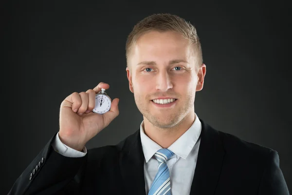 Zakenman bedrijf stopwatch — Stockfoto