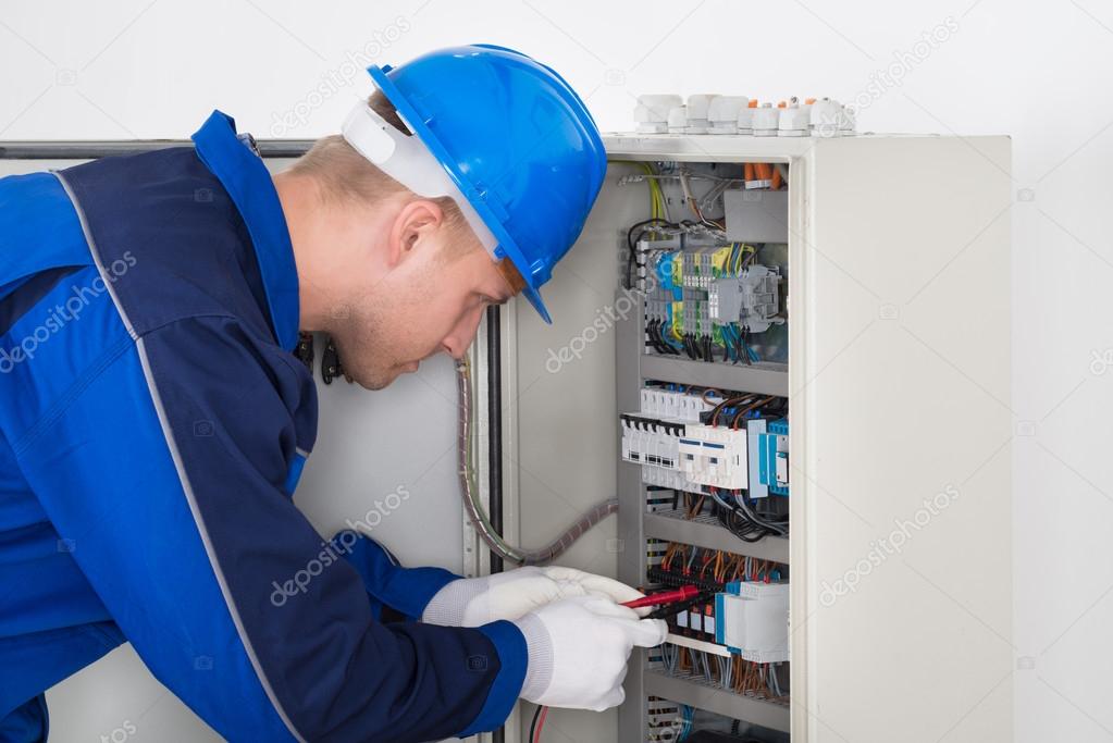 Male Technician Examining Fusebox