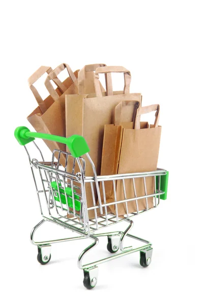 Trolley with paper bags  isolated on white — Stock Photo, Image