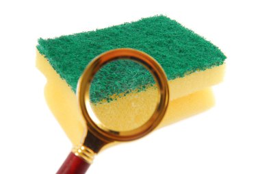 Kithen sponge and magnifying glass the concept of bacteria clipart