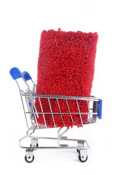 Shopping trolley with carpet isoalted — Stock Photo, Image