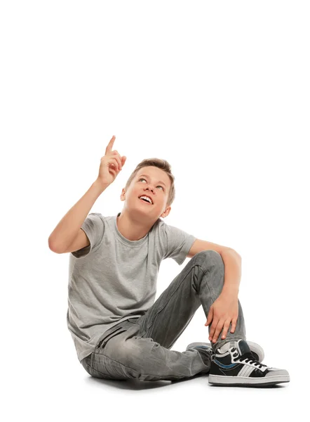 Smiling teenager points up — Stock Photo, Image