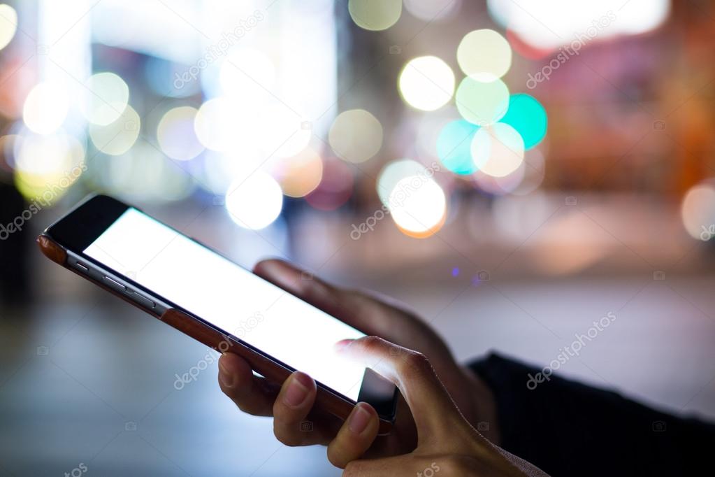 Woman using cellphone with blank screen