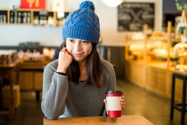 Kafede kahve fincanı tutan kadın