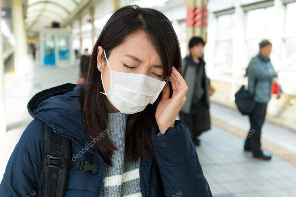 Woman feeling unwelling in train station