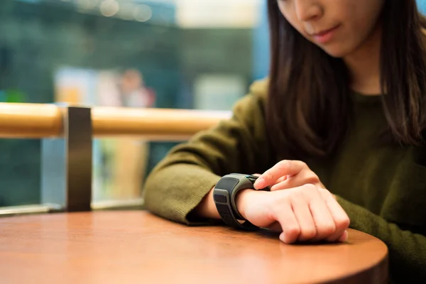 Woman use of touch on the smart watch — Stock Photo, Image