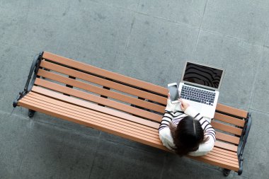 Akıllı telefon ve dizüstü bilgisayar kullanan kadın