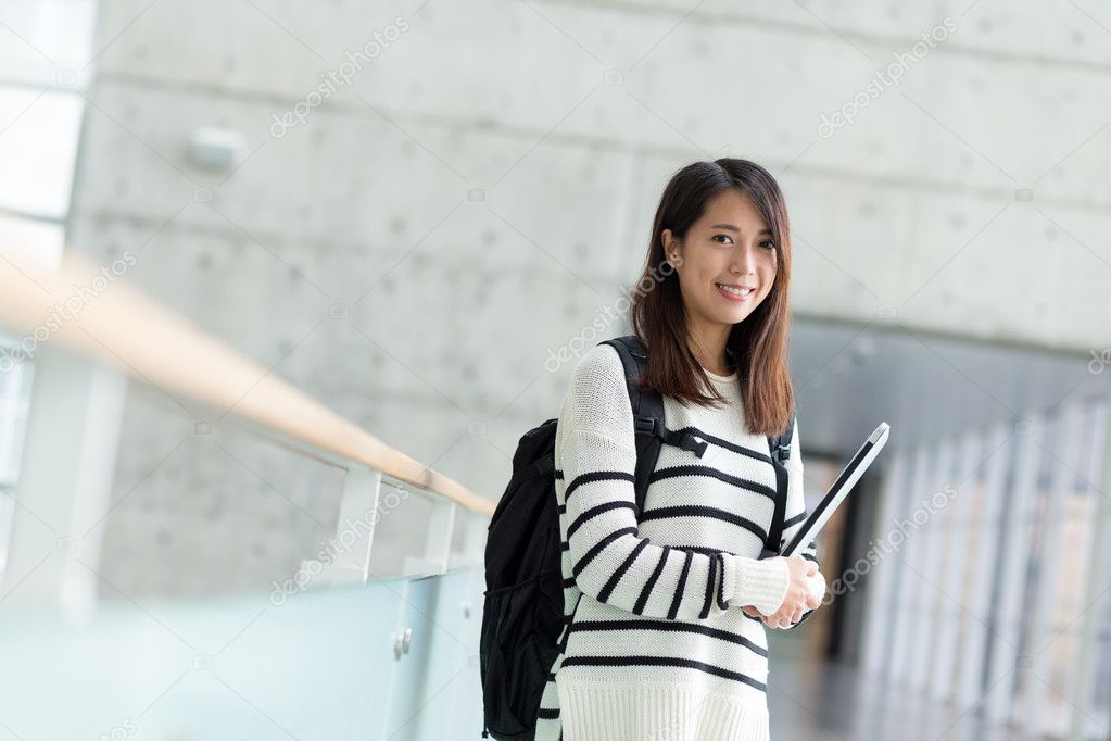 female student with notebook computer and backpack