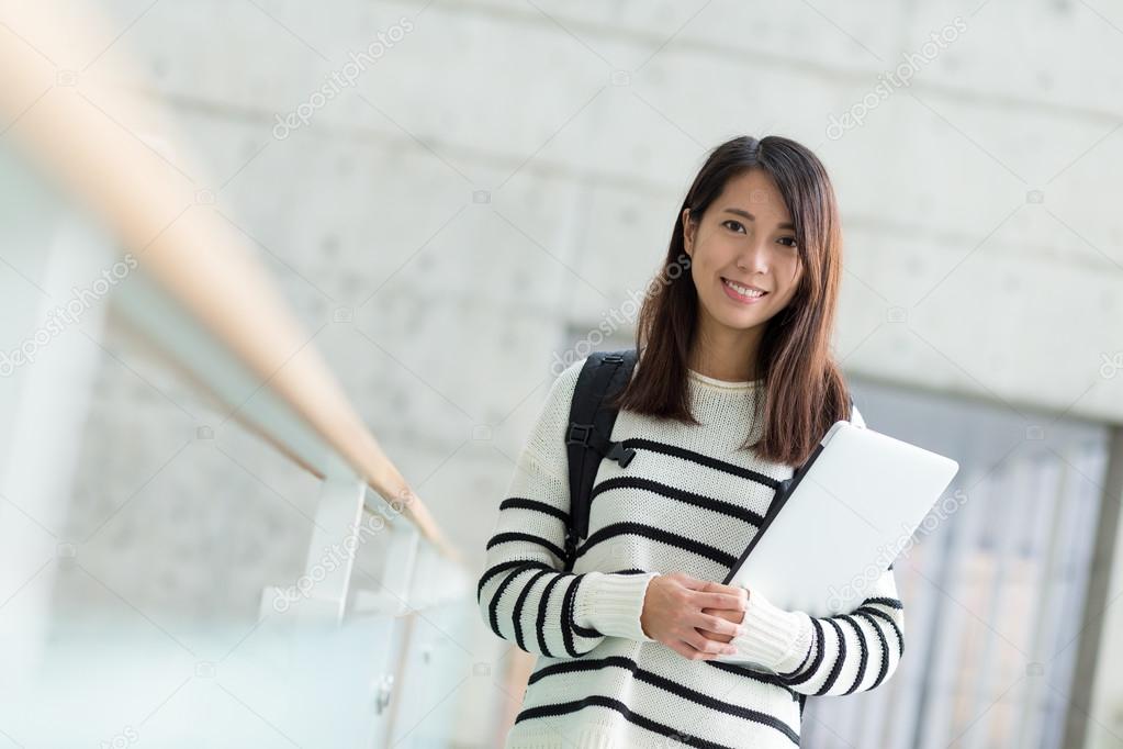 female student with notebook computer and backpack