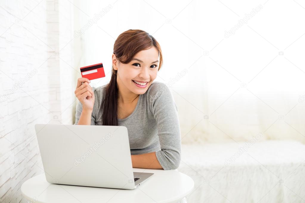 Woman using laptop computer for online shopping