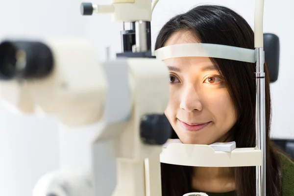 Mujer haciendo pruebas oculares en clínica óptica — Foto de Stock