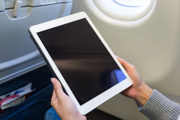 Woman using  tablet in airplane — Stock Photo, Image