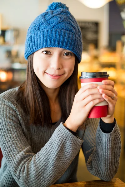Woman with coffee cup at cafe