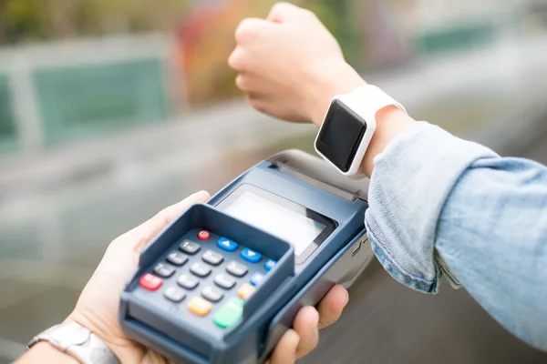 Mujer pagando la cuenta con un reloj inteligente — Foto de Stock