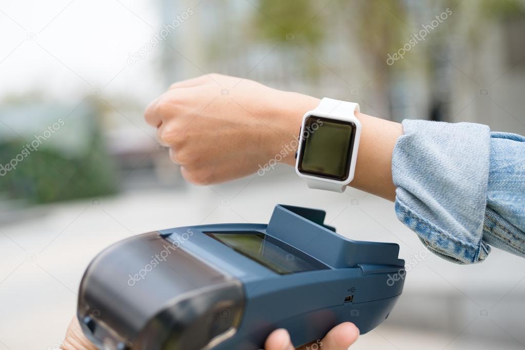 Customer using wearable watch to checkout