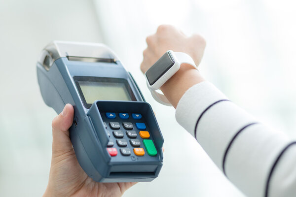 Woman paying the bill by smart watch 