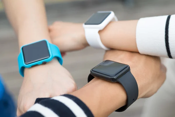 Friends using smart watches together — Stock Photo, Image