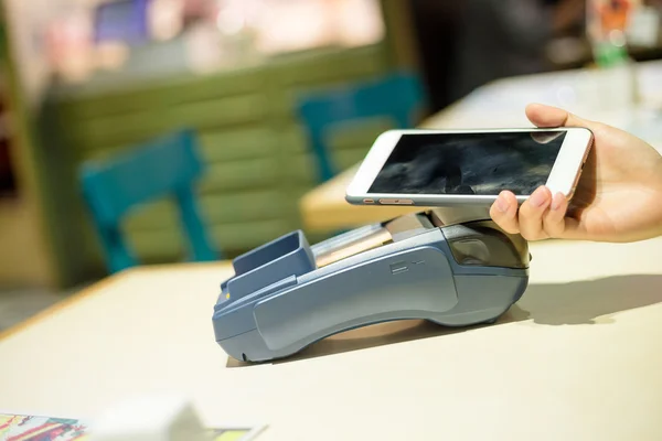 Mujer usando el teléfono celular para pagar la factura —  Fotos de Stock