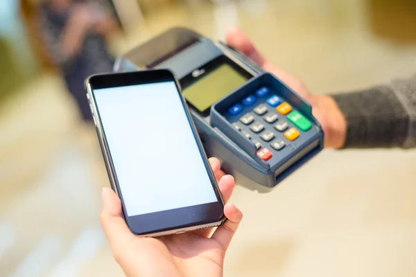 Woman using smart phone for paying the bill — Stok fotoğraf