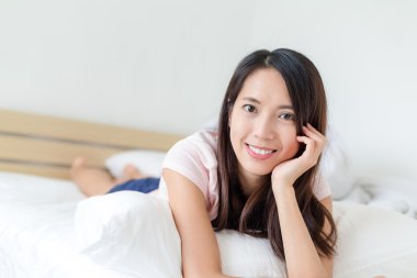 Kadın yatağa uzanıyor.