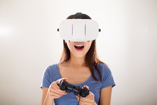 Woman playing video games with VR device