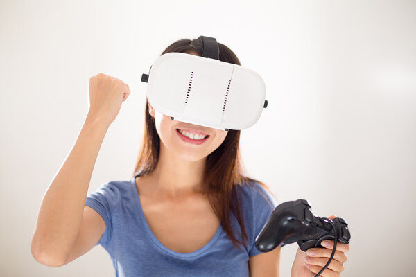 Woman playing video games with VR device