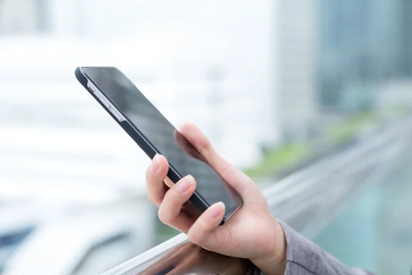 Woman using a touchscreen smartphone — Stock Photo, Image