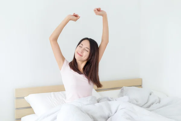 Woman stretching in bed at home — Stock Photo, Image
