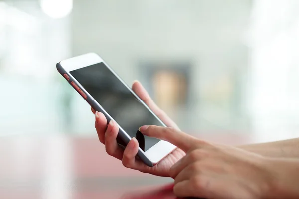 Manos humanas sosteniendo el teléfono inteligente — Foto de Stock