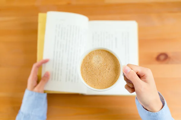 Vrouw lezen boek en drank van koffie — Stockfoto