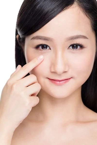 Woman with finger applying skincare on face — Stock Photo, Image