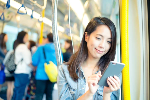 Mujer usando teléfono móvil dentro del tren — Foto de Stock