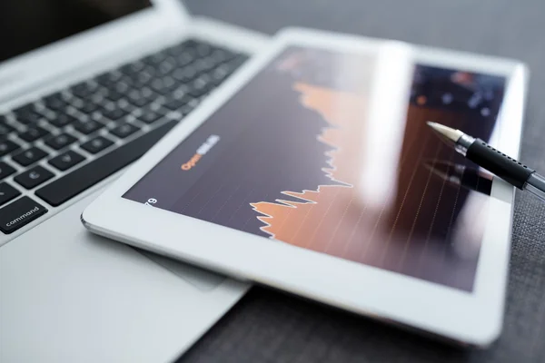 Digital tablet with business charts on a screen — Stock Photo, Image
